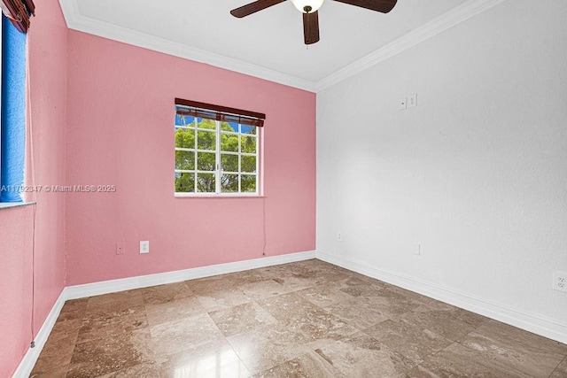 spare room with ornamental molding, stone tile floors, ceiling fan, and baseboards
