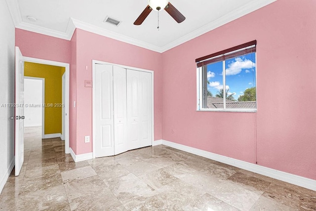 unfurnished bedroom featuring ornamental molding, a closet, visible vents, and baseboards