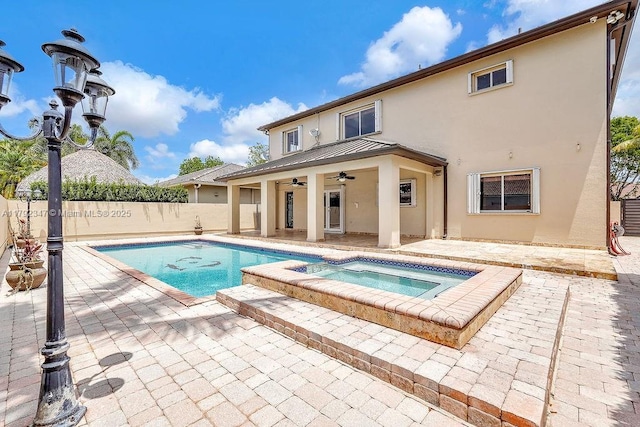 view of swimming pool featuring a patio area, a fenced in pool, ceiling fan, an in ground hot tub, and fence