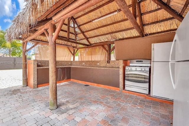 view of patio / terrace featuring an outdoor kitchen and a gazebo