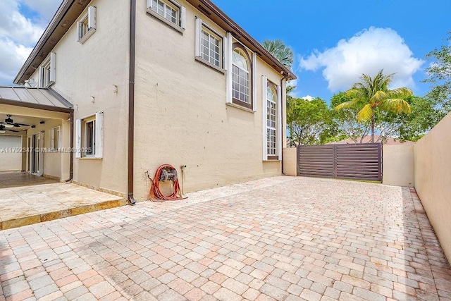 exterior space featuring ceiling fan and a fenced backyard