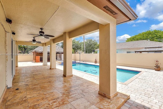 view of pool with ceiling fan, a fenced backyard, a fenced in pool, and a patio area