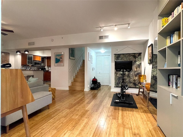 888 S Douglas Rd Unit 119, Coral Gables, FL 33134 - exercise area with visible vents, ceiling fan, light wood-style flooring, and baseboards