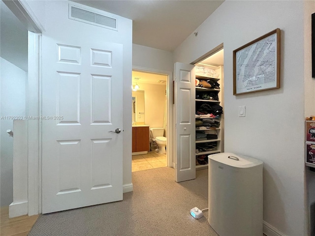 888 S Douglas Rd Unit 119, Coral Gables, FL 33134 - hall featuring visible vents, light carpet, and baseboards
