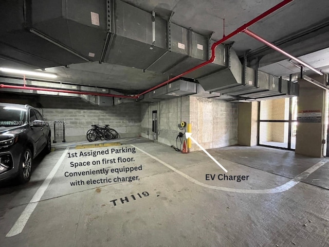 888 S Douglas Rd Unit 119, Coral Gables, FL 33134 - parking garage featuring concrete block wall