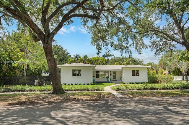ranch-style home with fence