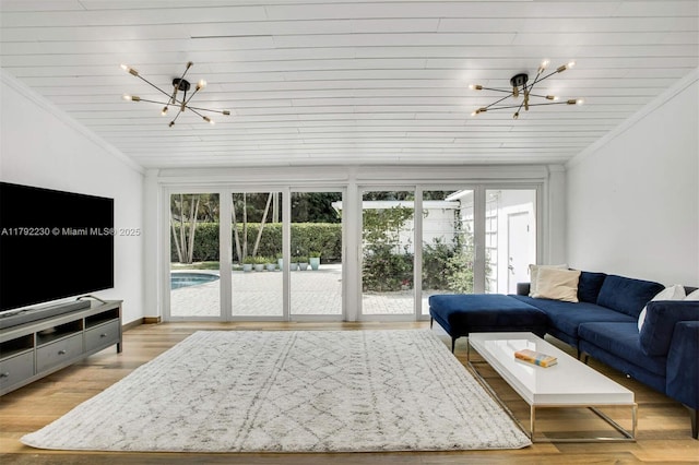 living area with wood ceiling, ornamental molding, a notable chandelier, and light wood-style floors
