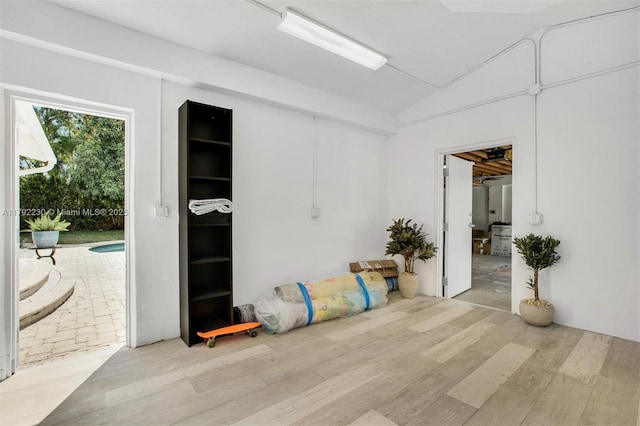 interior space featuring wood finished floors and vaulted ceiling