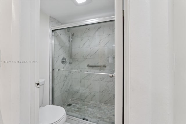 full bathroom with toilet and a shower stall