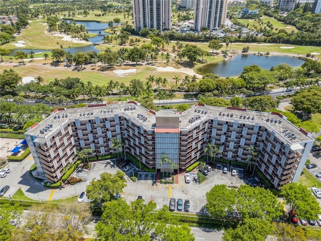 birds eye view of property featuring a water view and view of golf course