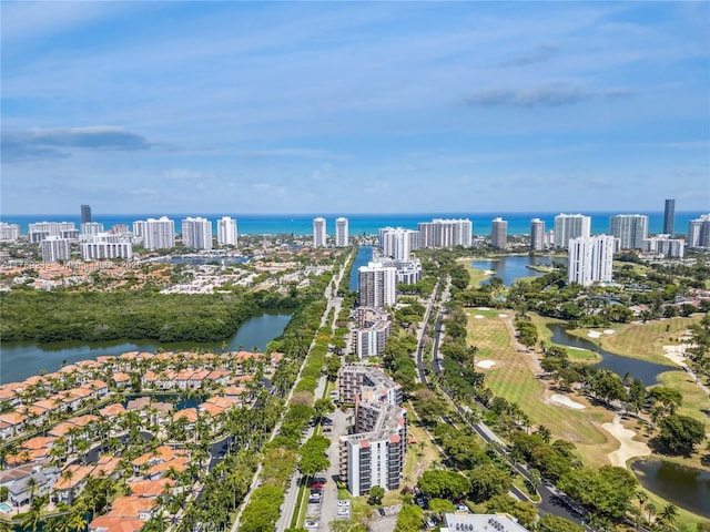 birds eye view of property featuring a water view, golf course view, and a view of city