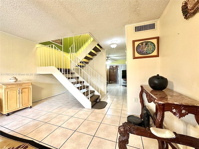 8135 W 9th Ave, Hialeah, FL 33014 - stairway featuring tile patterned floors, visible vents, ceiling fan, and a textured ceiling
