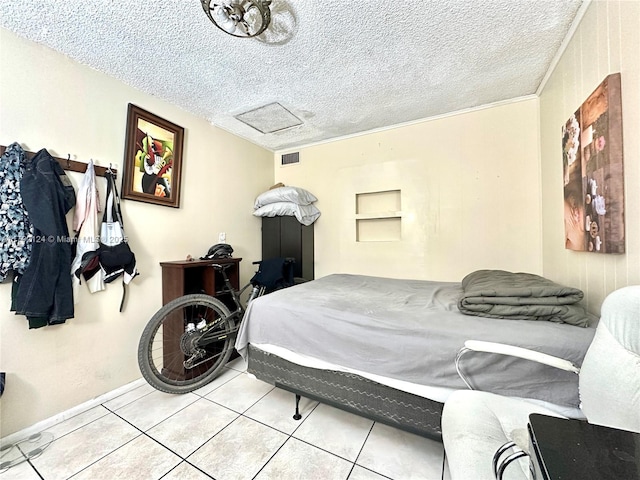 8135 W 9th Ave, Hialeah, FL 33014 - tiled bedroom featuring attic access, visible vents, a textured ceiling, and baseboards
