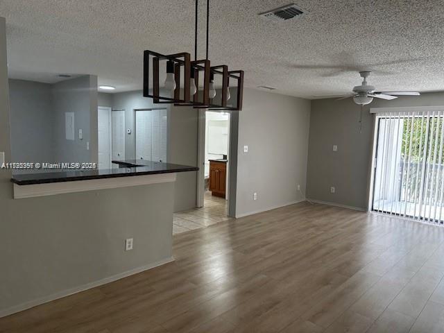 11229 W Atlantic Blvd Unit 204, Coral Springs, FL 33071 - interior space with a textured ceiling, visible vents, a ceiling fan, and light wood-style floors