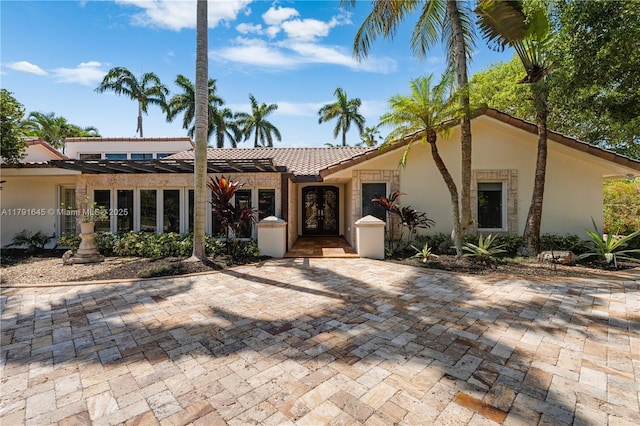 view of front of home featuring stucco siding and french doors