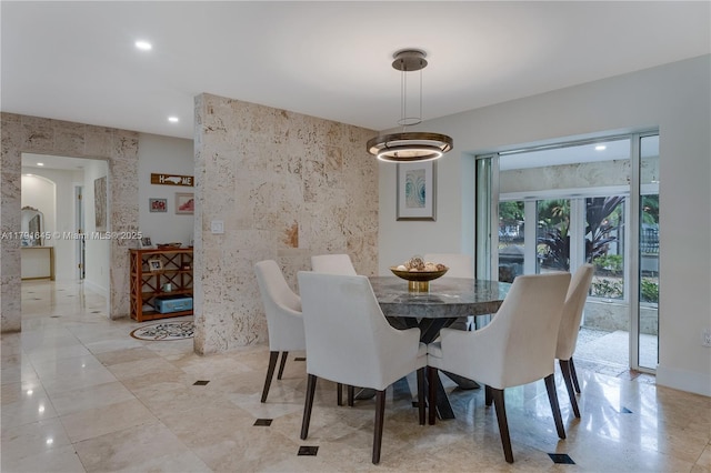 dining area featuring recessed lighting and tile walls