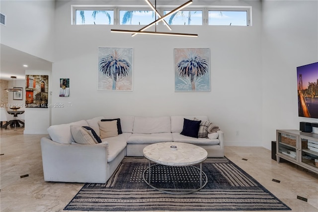 living room with a towering ceiling and visible vents