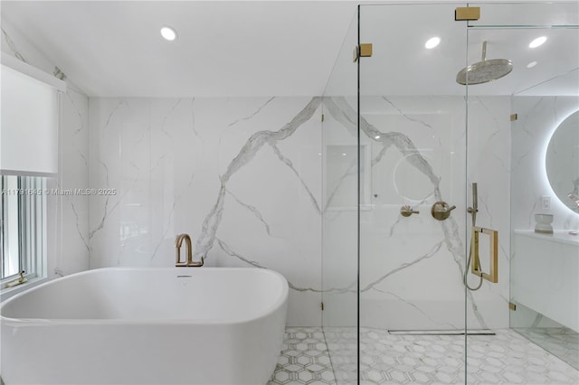 bathroom with recessed lighting, tile walls, tile patterned floors, a marble finish shower, and a freestanding bath