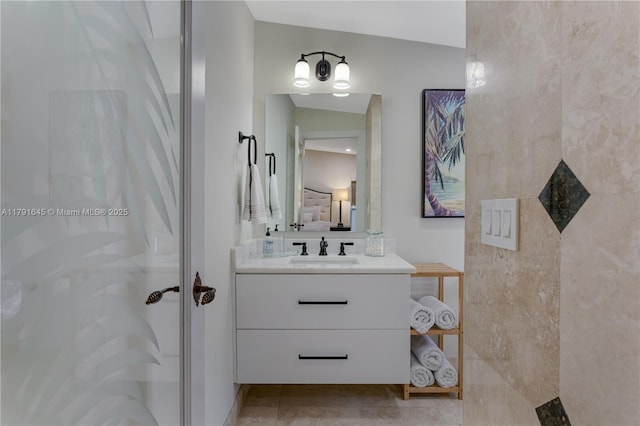 bathroom featuring a stall shower, connected bathroom, and vanity