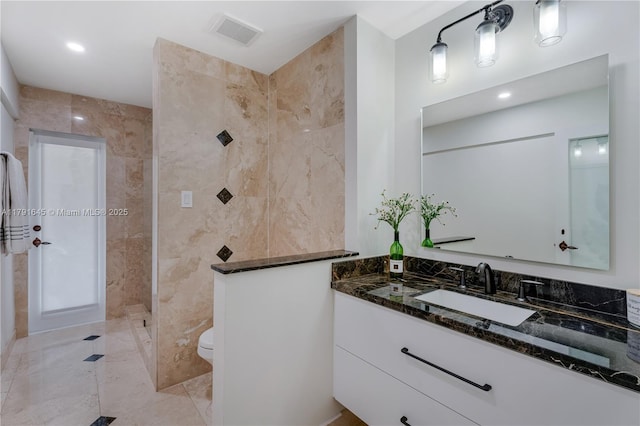 bathroom with recessed lighting, vanity, a walk in shower, toilet, and visible vents
