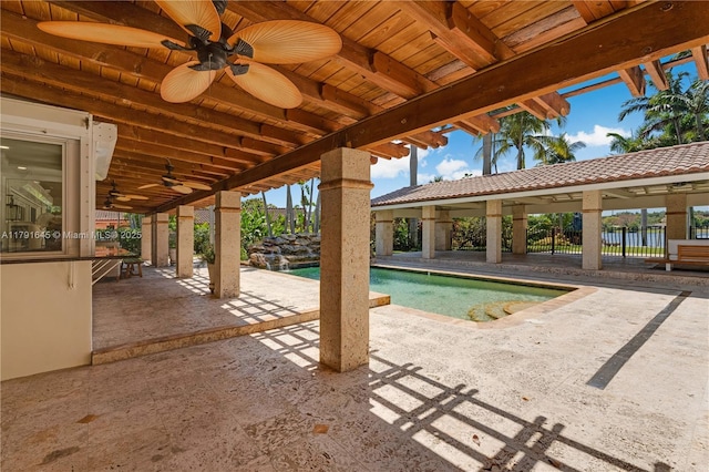 pool featuring a patio, a ceiling fan, and fence
