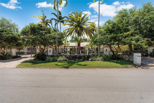 view of front of home with a fenced front yard and a gate