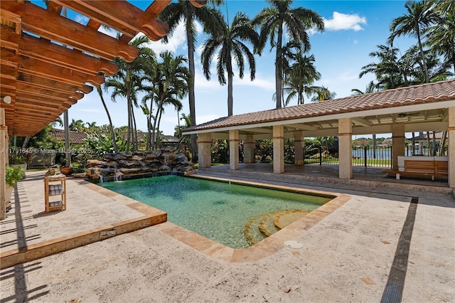 pool featuring fence and a patio area