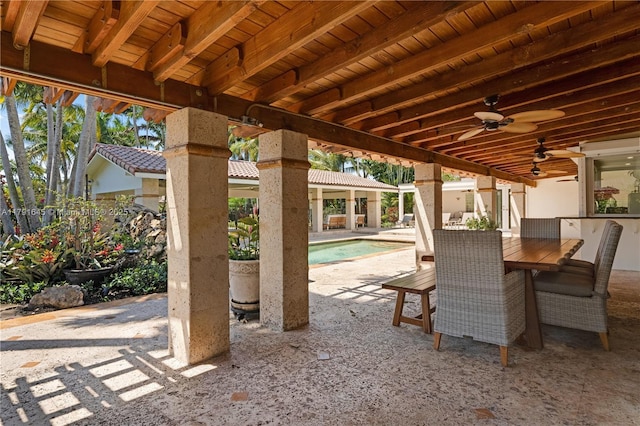 view of patio / terrace with a ceiling fan and an outdoor pool