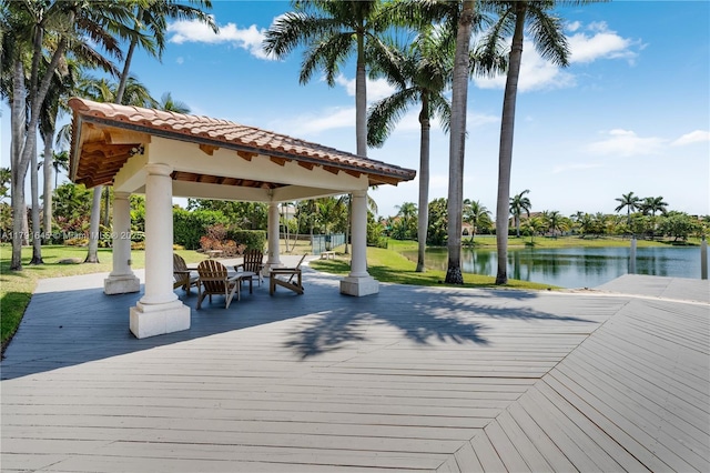 view of home's community with a gazebo and a deck with water view