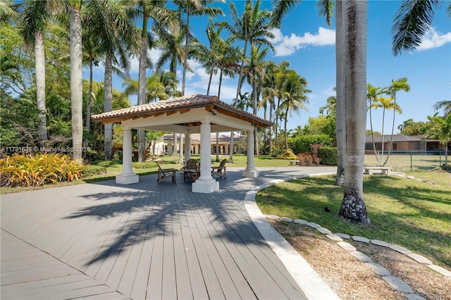 surrounding community with fence, a gazebo, and a yard