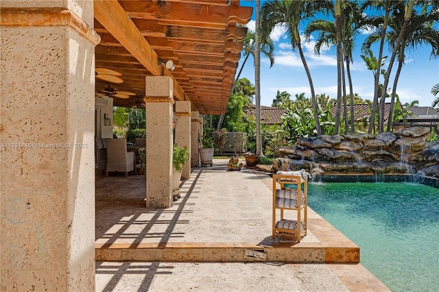 view of patio / terrace featuring fence, an outdoor pool, and a ceiling fan