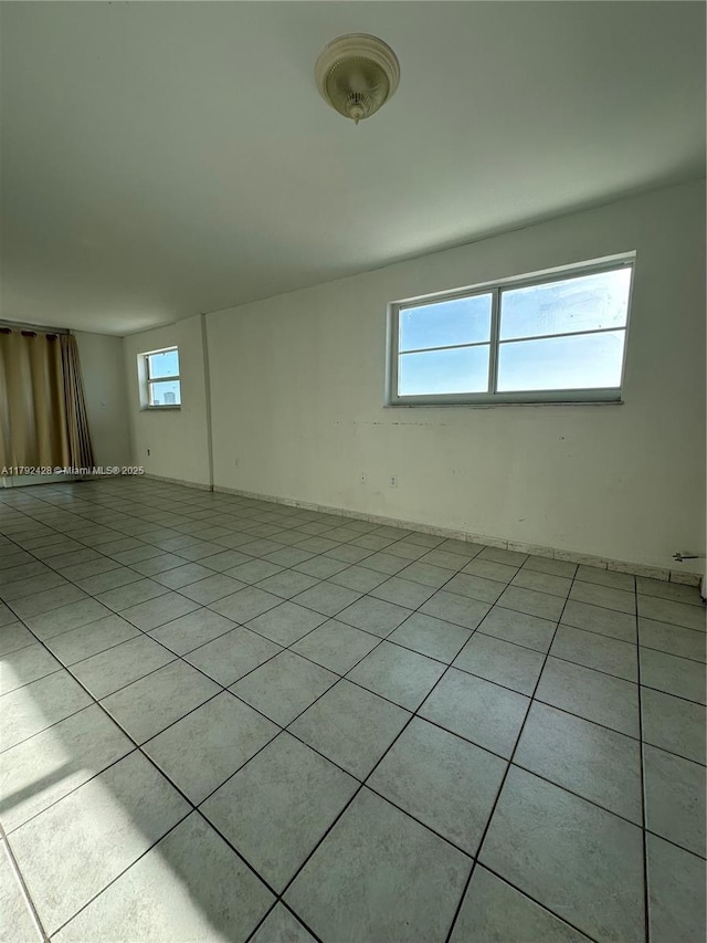 spare room with light tile patterned floors