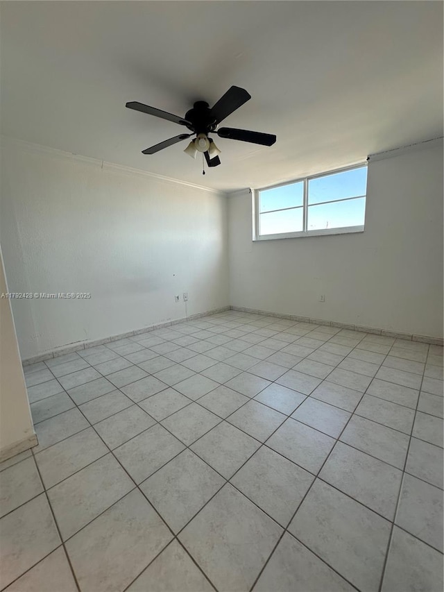 unfurnished room featuring light tile patterned floors, a ceiling fan, and crown molding