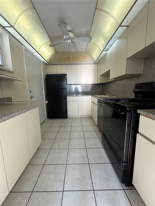 kitchen with light tile patterned floors, black appliances, ceiling fan, and a sink