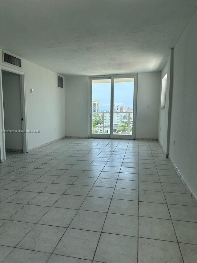1750 James Ave Unit 10A, Miami Beach, FL 33139 - unfurnished room featuring light tile patterned floors and baseboards