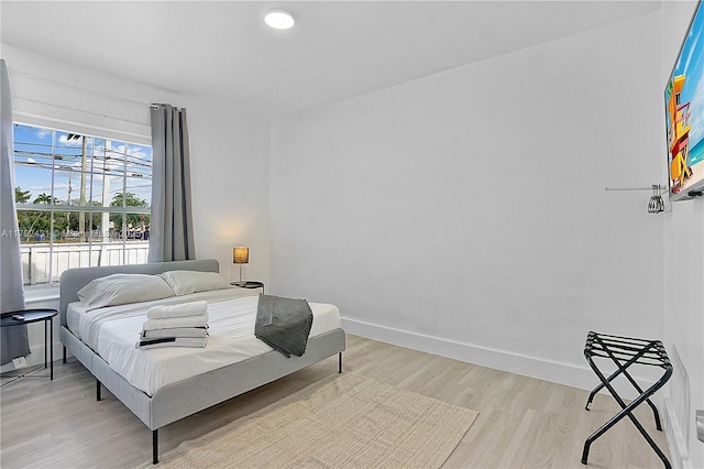 bedroom featuring baseboards and light wood-type flooring
