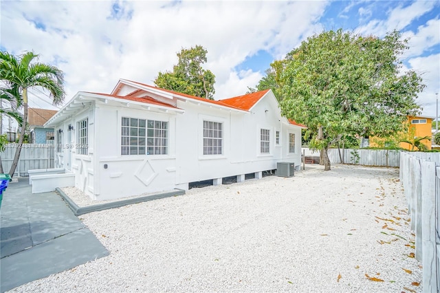exterior space with central AC and a fenced backyard