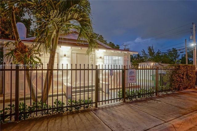 view of gate with a fenced front yard