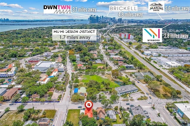birds eye view of property featuring a view of city and a water view