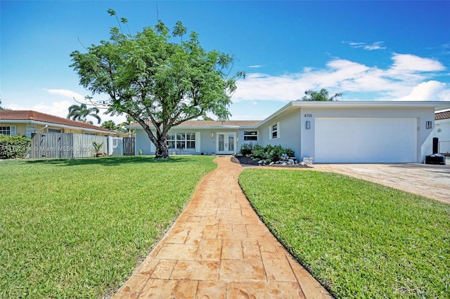 4701 Garfield St, Hollywood, FL 33021 - ranch-style home featuring stucco siding, a front yard, an attached garage, fence, and french doors