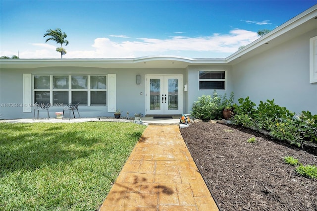 4701 Garfield St, Hollywood, FL 33021 - doorway to property featuring a lawn, stucco siding, and french doors