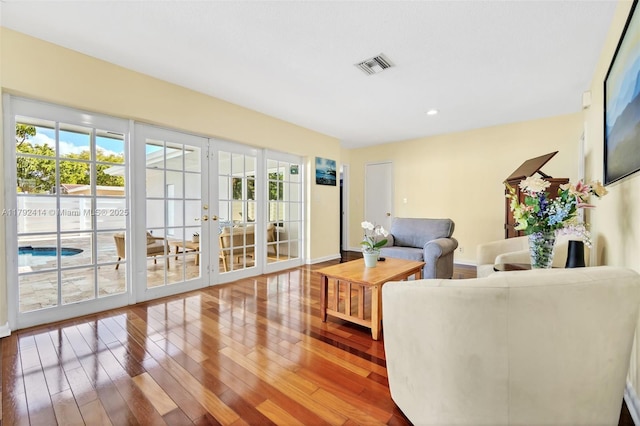 4701 Garfield St, Hollywood, FL 33021 - living room featuring recessed lighting, hardwood / wood-style floors, baseboards, visible vents, and french doors