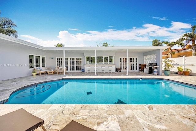 4701 Garfield St, Hollywood, FL 33021 - outdoor pool with fence, a patio, area for grilling, outdoor lounge area, and french doors