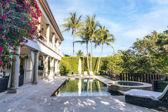 view of swimming pool featuring a patio and a pool with connected hot tub