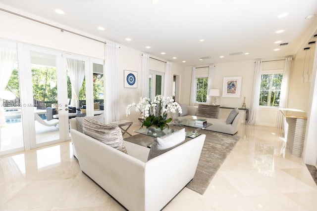 living room with french doors, recessed lighting, and marble finish floor