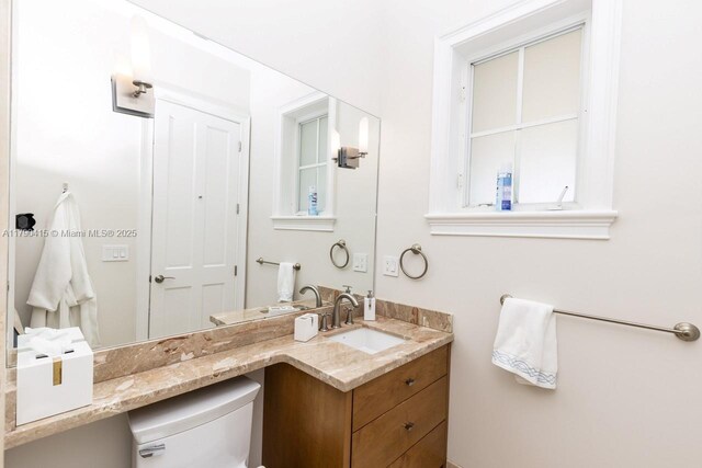 bathroom with toilet and vanity