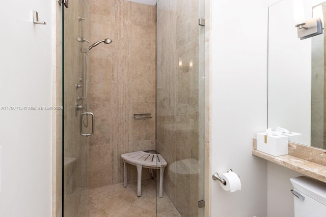full bath with a stall shower and toilet