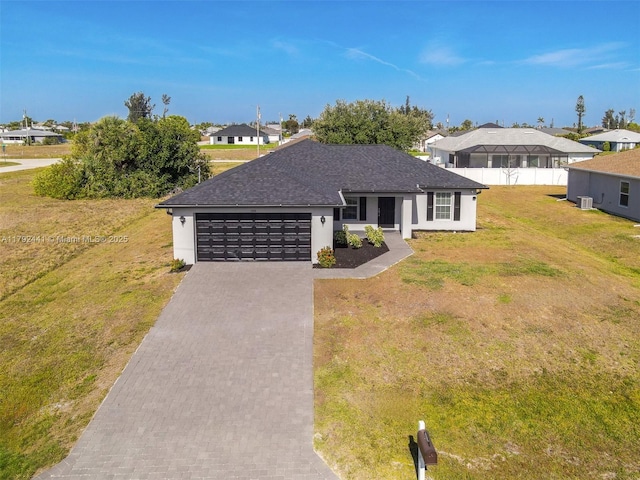 1808 NE 7th Ave, Cape Coral, FL 33909 - ranch-style home with a front yard, a residential view, stucco siding, driveway, and an attached garage