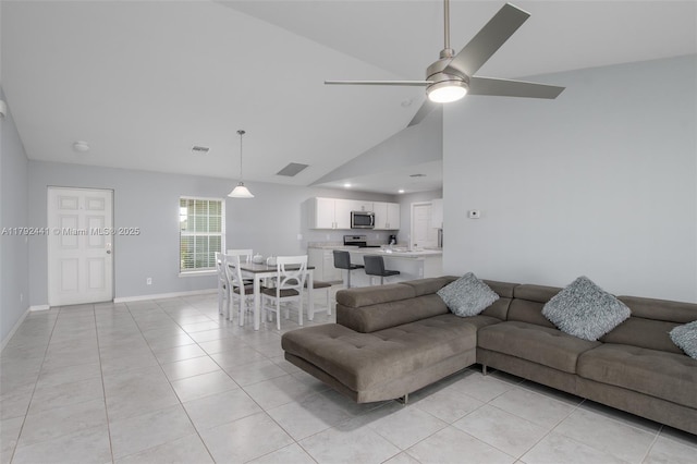 1808 NE 7th Ave, Cape Coral, FL 33909 - living area featuring light tile patterned floors, visible vents, baseboards, a ceiling fan, and high vaulted ceiling
