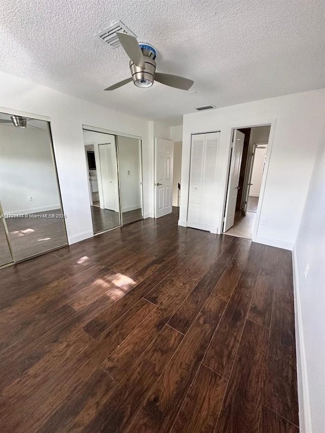 12025 SW 10th St Unit 204, Miami, FL 33184 - unfurnished bedroom featuring baseboards, wood finished floors, a textured ceiling, and multiple closets